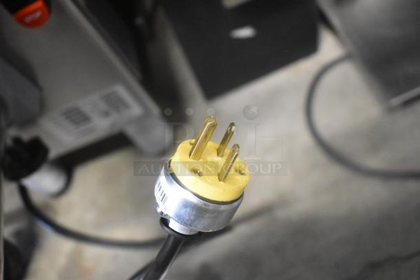 Close-up of yellow power plug on Pro-cut KG-22W-XP-SS meat grinder, 220V, 1 phase. Stainless steel commercial countertop model.