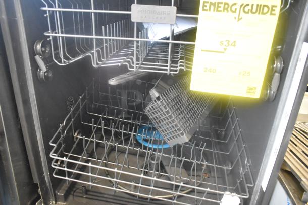 Frigidaire GDPH4515AF2B undercounter dishwasher, open view. Features include racks, utensil basket, and energy guide label.