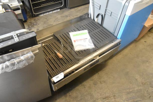 EmberGlo stainless steel commercial countertop charbroiler grill, featuring cast iron grates, in good condition. Marked as lot 123.