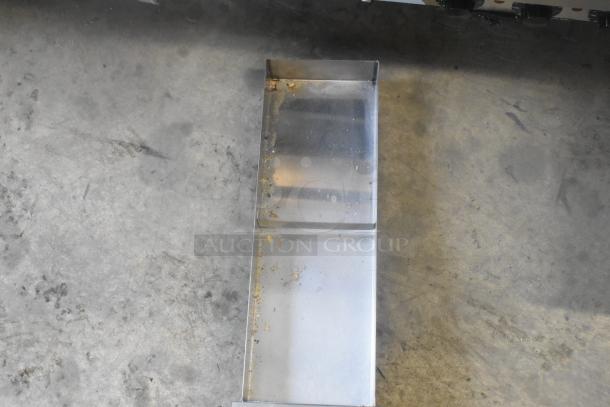 EmberGlo Stainless Steel Commercial Charbroiler Grill, showing a close-up of the drip tray with minor residue.