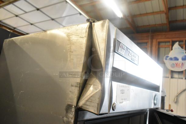 2017 True T-19F stainless steel commercial freezer with visible dents and True brand label. Single door, 115 volts, poly-coated racks.
