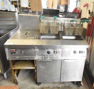 Frymaster FM245ESC stainless steel 2-bay deep fat fryer with dumping station, 4 metal baskets, on commercial casters, 122,000 BTU.
