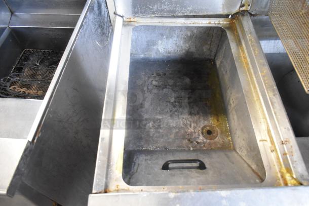 Frymaster FM245ESC stainless steel 2-bay deep fat fryer with dumping station, 4 baskets, commercial casters, 122,000 BTU.