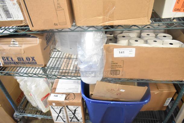 Boxes containing receipt printer rolls, sanitizer bottles, and other items on metal shelves. Auction lot labeled "141."
