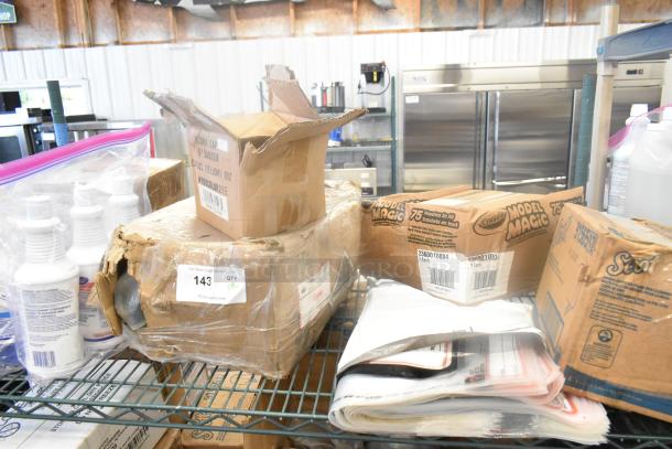 Eight various items including toilet bowl cleaner, Zebra labels, and plates in partially opened boxes on a metal shelf. Auction lot with visible tags.