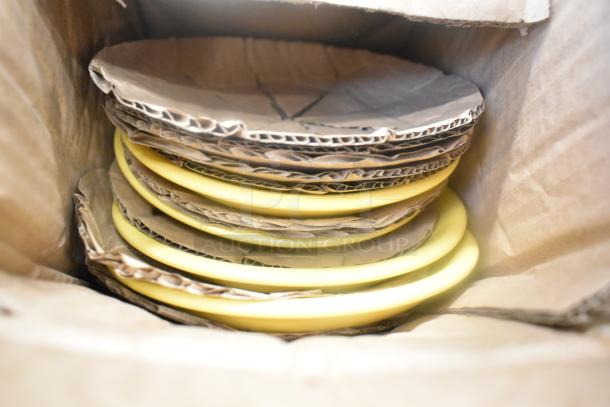 Cardboard box containing stacked yellow plates with protective cardboard dividers, part of an 8-item auction lot.