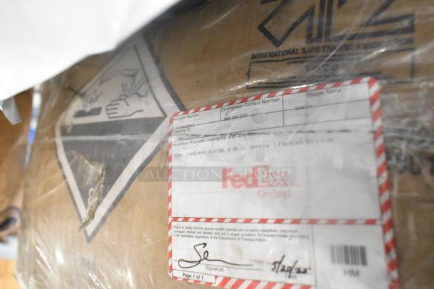 Box with FedEx label, hazardous materials warning, includes items like toilet bowl cleaner, Zebra labels, plates.