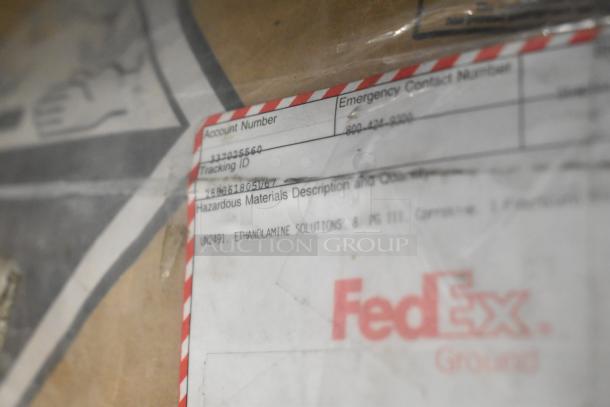 FedEx package label showing tracking ID and hazardous materials description for ethanolamine solutions.
