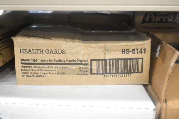 Box of Health Gards waxed paper liners for sanitary napkin disposal, 250 per case, model HS-6141, barcode visible.