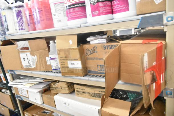 11 assorted items on a shelf including Scott dispenser box, Diversey sanitizer bottles, and crayon packages. Various conditions.