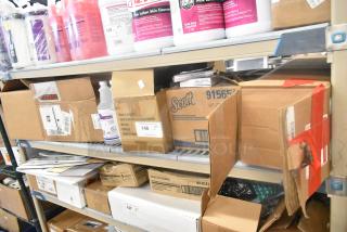 11 assorted items on a shelf including Scott dispenser box, Diversey sanitizer bottles, and crayon packages. Various conditions.