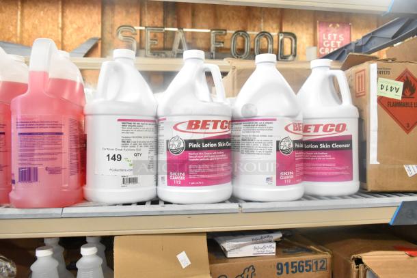 Bettco Pink Lotion Skin Cleanser gallon bottles on a shelf. Labels show product details and "Tier Lot" auction info.