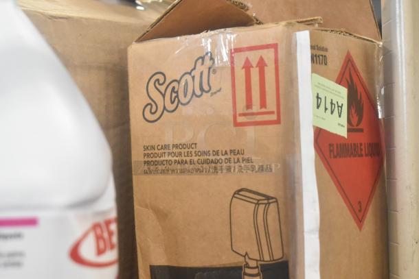 Tier lot with Scott skin care product box and labeled flammable liquid. Includes Bettco Skin Cleanser and disinfecting wipes.