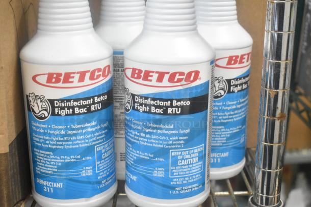 Bottles of Betco Disinfectant Fight Bac RTU on a shelf, labeled as tuberculocidal, virucidal, and fungicidal, 1-quart size.