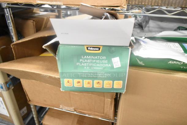 Fellowes laminator box, 9.5-inch model, sealed, on a shelf with other assorted items, including Betco disinfectant and bath tissue.