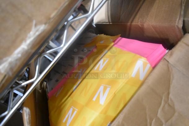 Box containing various items, including Betco Disinfectant, jumbo bath tissue roll, and laminator. Assorted supplies in cardboard box.