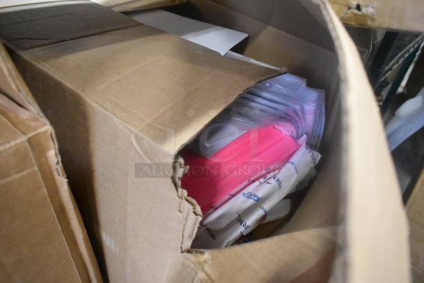Box of assorted items including paper packs and packaging materials. Condition shows partially opened box.