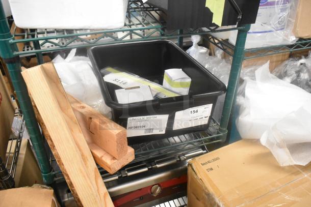 4 brand new scratch and dent items on shelf, including Lincoln 369194 belt conveyor, in labeled container.