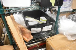 4 brand new scratch and dent items on shelf, including Lincoln 369194 belt conveyor, in labeled container.