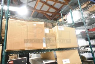 Cardboard boxes on shelves, including a Gojo Hand Cleaner box. Labels with lot numbers visible. Auction item: bid for four items.