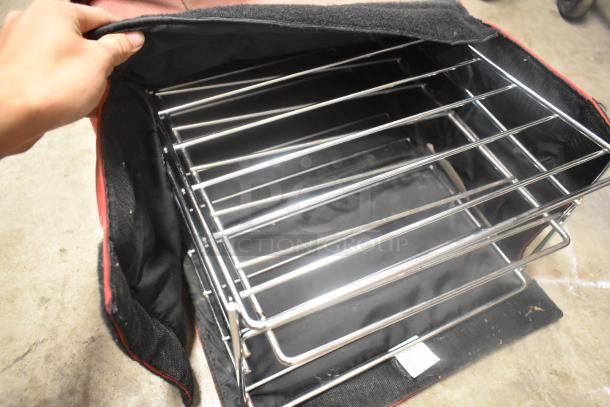 Red insulated food carrying bag with metal racks, open to show interior. Features durable fabric and built-in shelving.