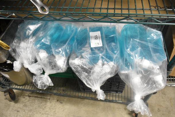 Four Rubbermaid foam lotion bags, sealed, with dispensing nozzles. Bags are transparent with blue liquid. Label reads "Item 112."