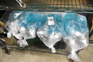 Four Rubbermaid foam lotion bags, sealed, with dispensing nozzles. Bags are transparent with blue liquid. Label reads "Item 112."