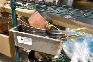 Eight metal kitchen items including skillets and a drop-in bin, visible wear, lot number 173, PCI Auctions tag.