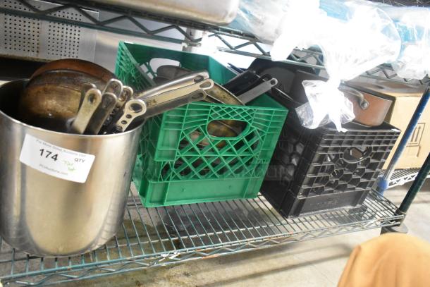 Tier lot with various items including metal skillets in crates. Auction label indicating "Tier Lot" with the number 174.