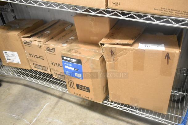 Boxes of Coastwide glass cleaner and Purell 9118-02 hand sanitizing wipes on a shelf, in unopened condition.