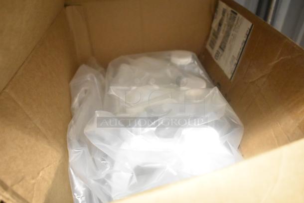 Cardboard box containing 7 various items, including Coastwide glass cleaner and Purell 9118-02 hand sanitizing wipes, wrapped in plastic.