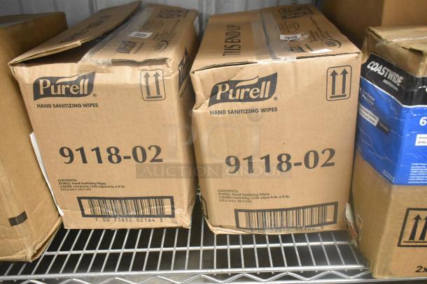Cardboard boxes of Purell 9118-02 hand sanitizing wipes and Coastwide glass cleaner, unopened, on a metal shelf.