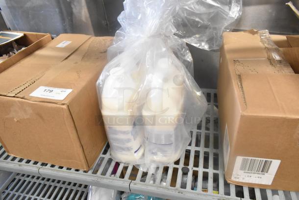 Seven items including boxes and plastic-wrapped bottles on a metal shelf. Box labeled with "179," possible inventory or lot number.