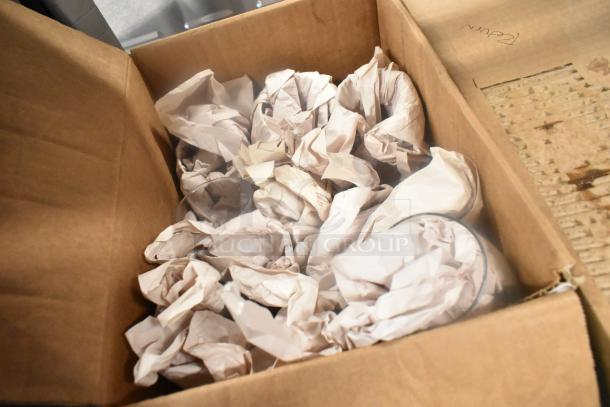 Box with 7 various items including glasses, wrapped in crumpled paper. Cardboard marked "Return." Auction: 7 times your bid!
