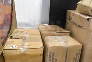 Boxes containing 8 items, including an Assure 190M22HSHRDR shredder attachment and poly drop-in bins. Packaging shows wear.