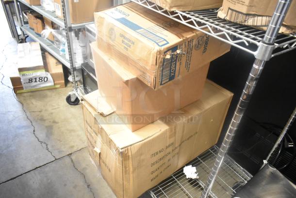 Boxes containing Dixie hot cup lids and solar flower lights on metal shelves, ready for auction. Labels visible with item details.