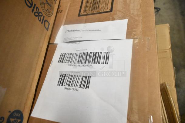 Cardboard box with label showing Dixie hot cup lids and solar flower lights. Includes Staples return shipping label.