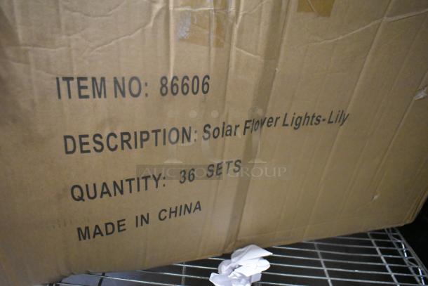Cardboard box labeled "Solar Flower Lights-Lily," Item No: 86606, Quantity: 36 Sets, Made in China.