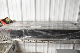 2024 SSDQ-DBL-36A Electric Fireplace, 120 Volts, 1 Phase, sealed in plastic, resting on a metal shelf.