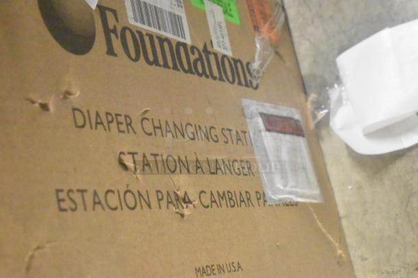 Foundations diaper changing station box, slightly worn; visible "Made in USA" label.