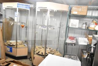 Glass merchandiser display case with wooden base, adjustable shelves, and price tags. Good condition. Suitable for retail display.