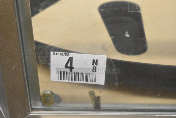 Merchandiser display case with metal frame, glass panel; visible label shows "01/12/25" and numeric code "4 N 8."