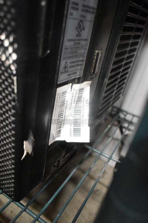 2022 window mount air conditioner, black, featuring a barcode label. Minimal wear, visible on a metal shelf.