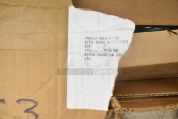 Cardboard box with visible torn label, addressed to Walmart Store in Baton Rouge, LA. Item in used condition.