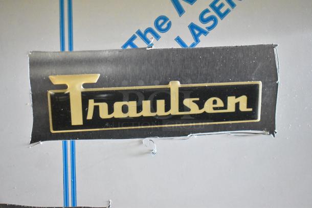 "Traulsen" logo on stainless steel finish of Traulsen UPT6024-LR sandwich salad prep table. Newly marked "scratch and dent."