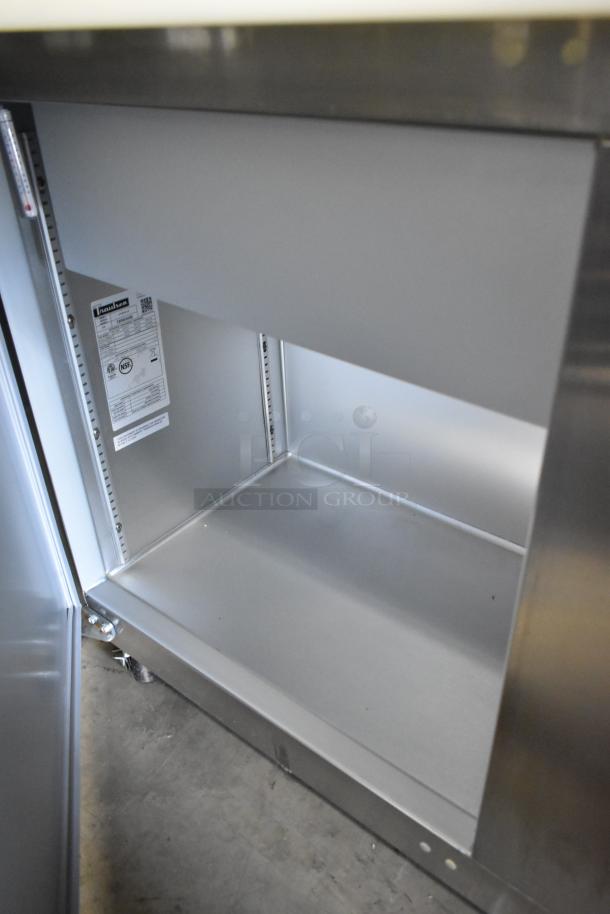 Brand new Traulsen UPT6024-LR stainless steel sandwich prep table, scratch and dent, NSF-certified, commercial casters shown.