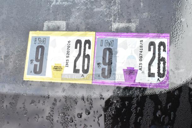 Close-up of 2016 Mazda CX-5 windshield with Pennsylvania inspection stickers, valid through September 2026.