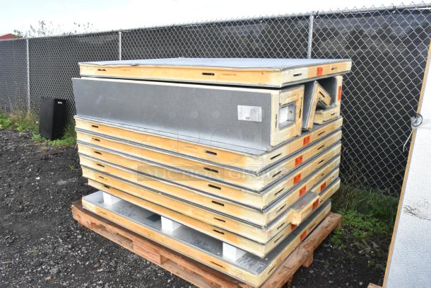 Norlake self-contained walk-in cooler box with CPB075PC-5-0 condenser and compressor; panels stacked outdoors, condition appears used.