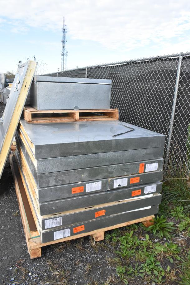 Norlake self-contained walk-in cooler box parts on pallets. Includes CPB075PC-5-0 condenser and compressor. Visible labels and tags.