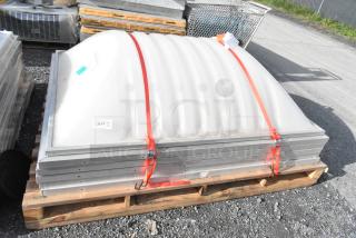 Stack of five dome covers with metal frames on a pallet, secured with red straps and marked "211". Ideal for skylight installations.